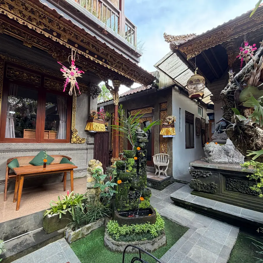 A Balinese courtyard with carved doors and plants
