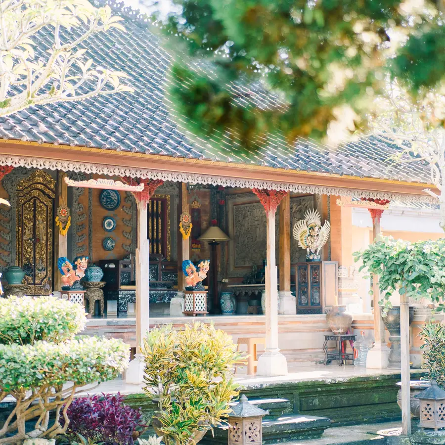 A traditional Balinese house behind a flowering garden