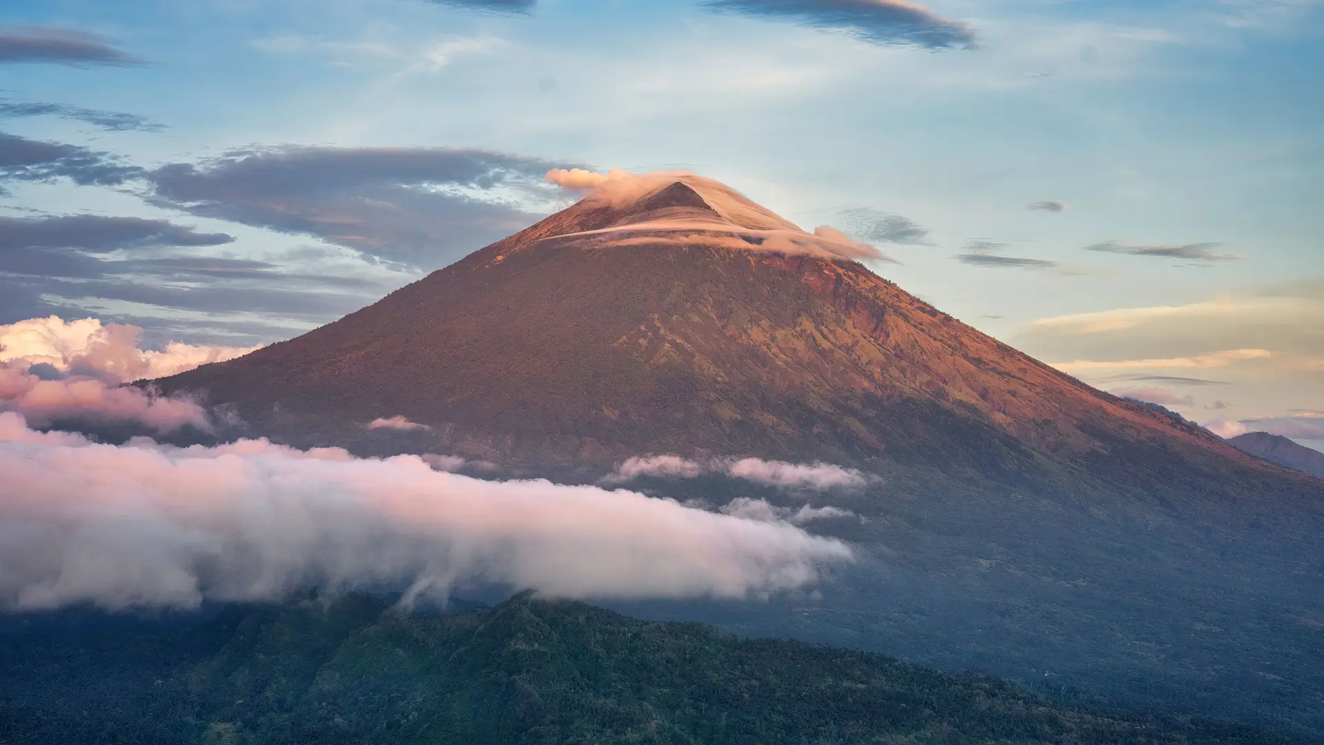 Mount Agung above the clouds at sunrise
