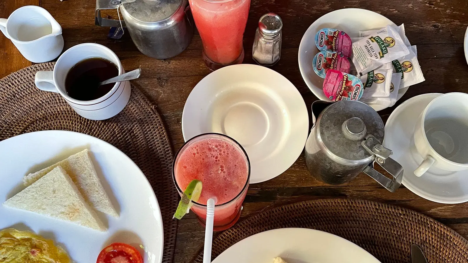 Breakfast plates with omelette, fruit and juice